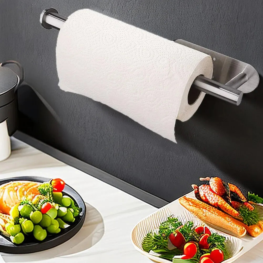 Wall mounted adhesive paper towel holder with a roll of paper towels
