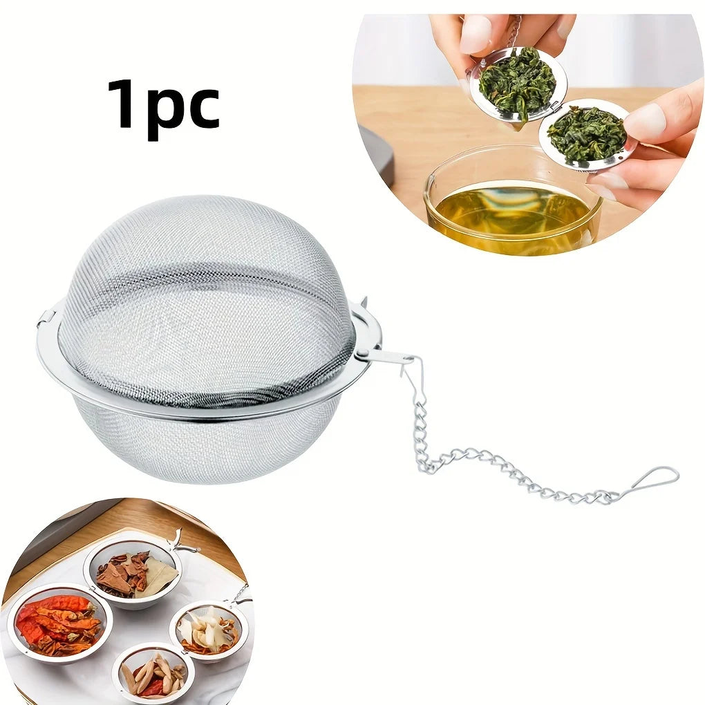 Stainless steel tea infuser ball with chain and loose tea leaves 