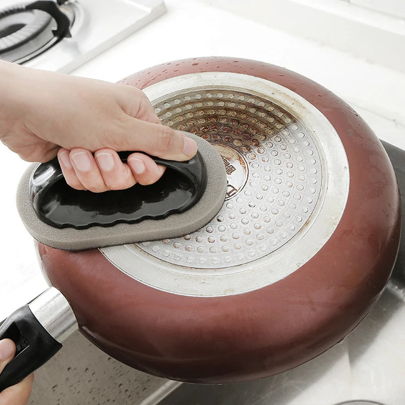 2-in-1 Kitchen scrub brush used to clean a dirty pan