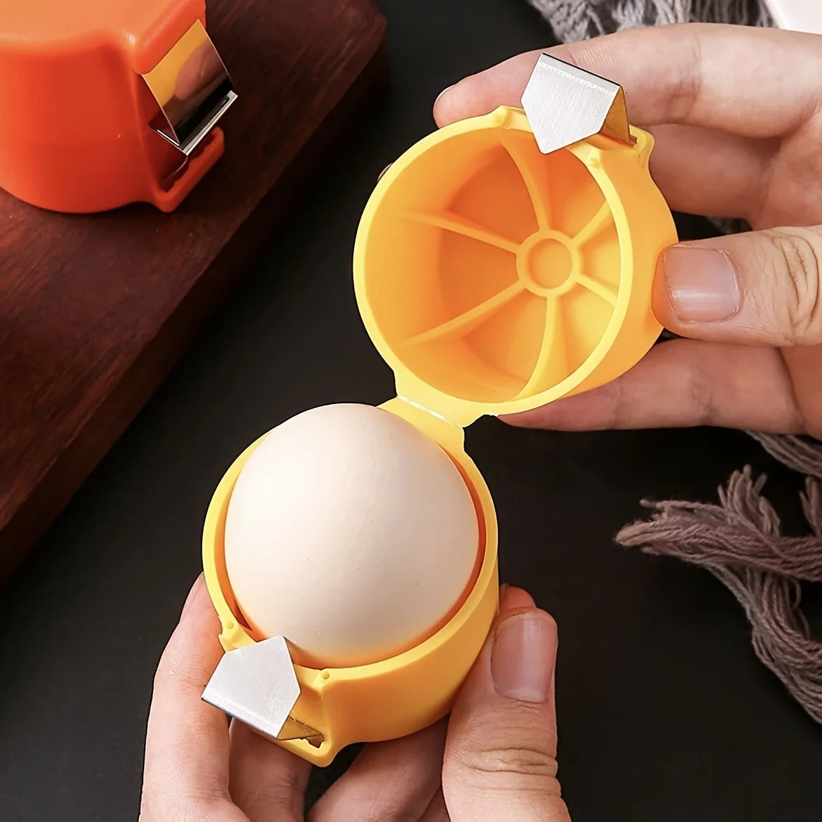 Yellow egg sheller opening an egg by hand 