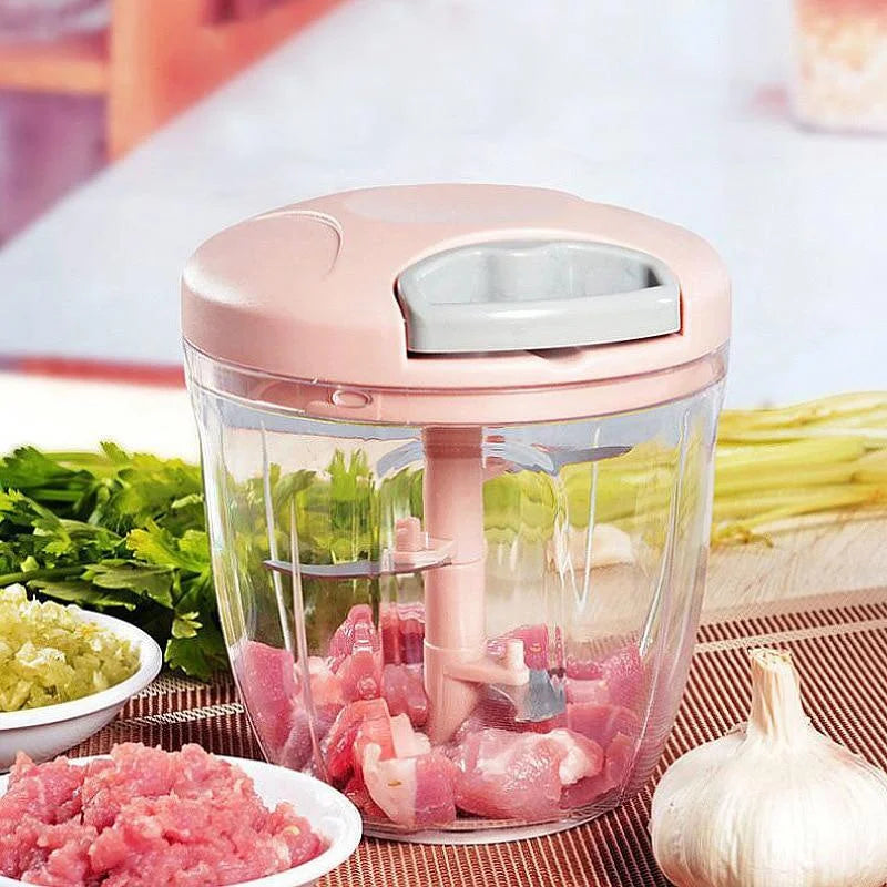 Manual garlic chopper with pink lid and chopped meat and vegetables inside 
