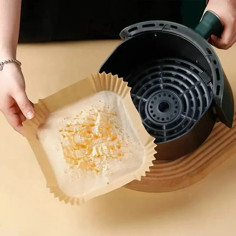 Parchment paper liner placed inside an ai fryer basket for cooking 