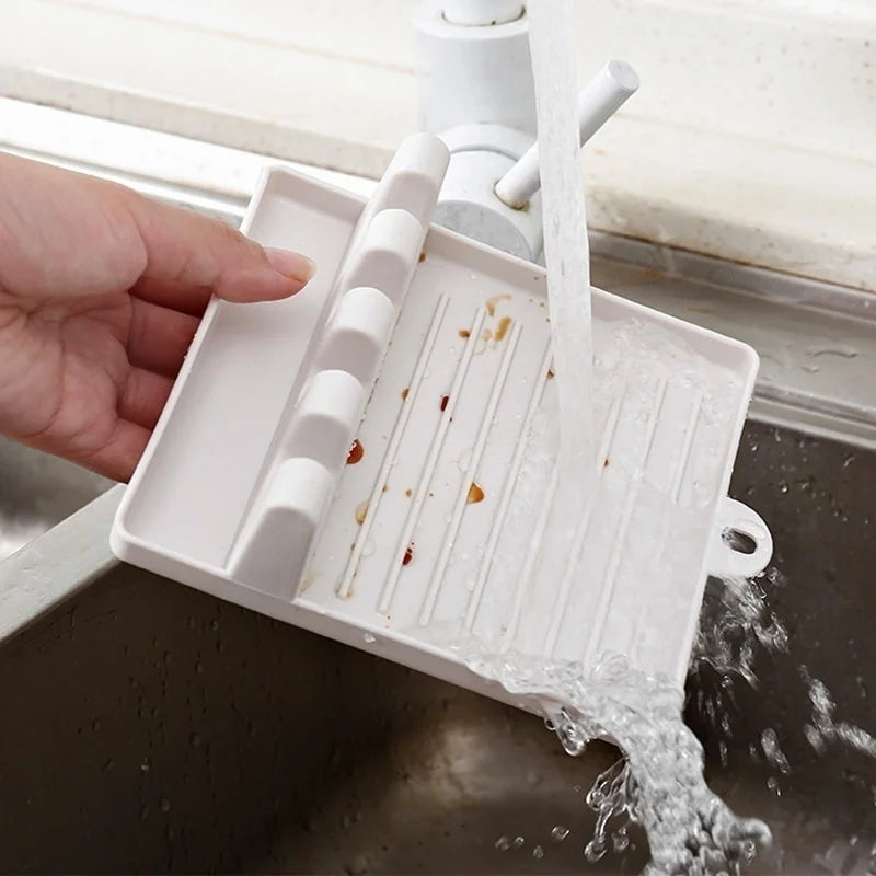 Kitchen utensil holder being rinsed under running water
