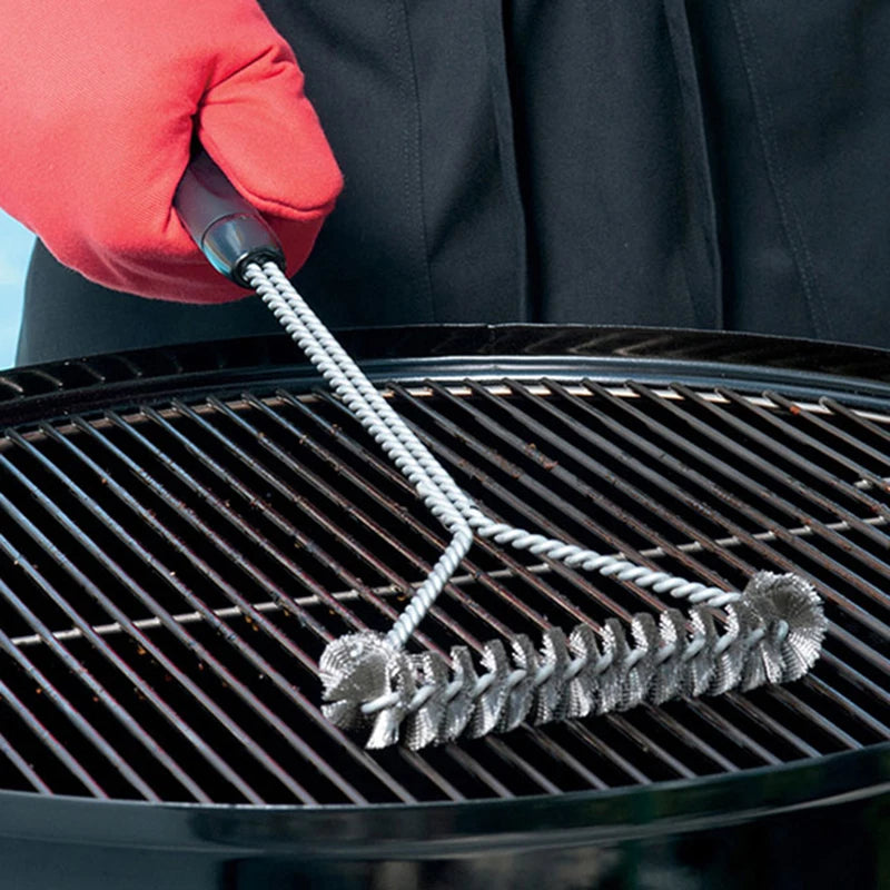 Barbecue grill cleaning brush removing residue from grill grates 