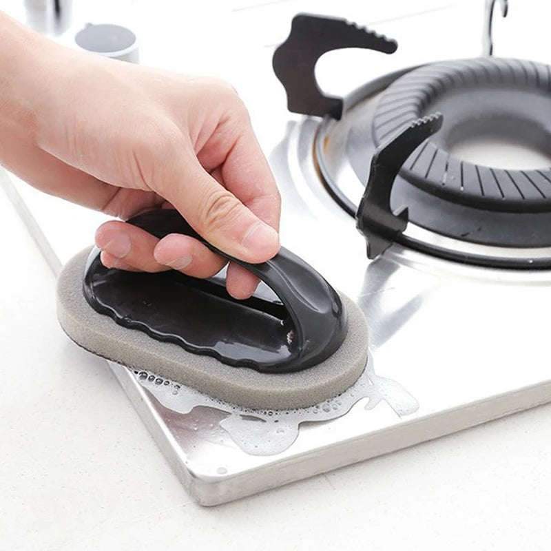 2-in-1 kitchen scrub brush used for cleaning a stovetop 